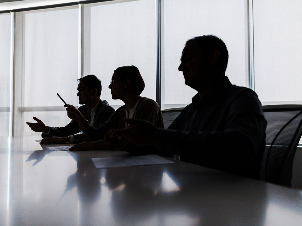 View of people at a conference table; iStock 637902194