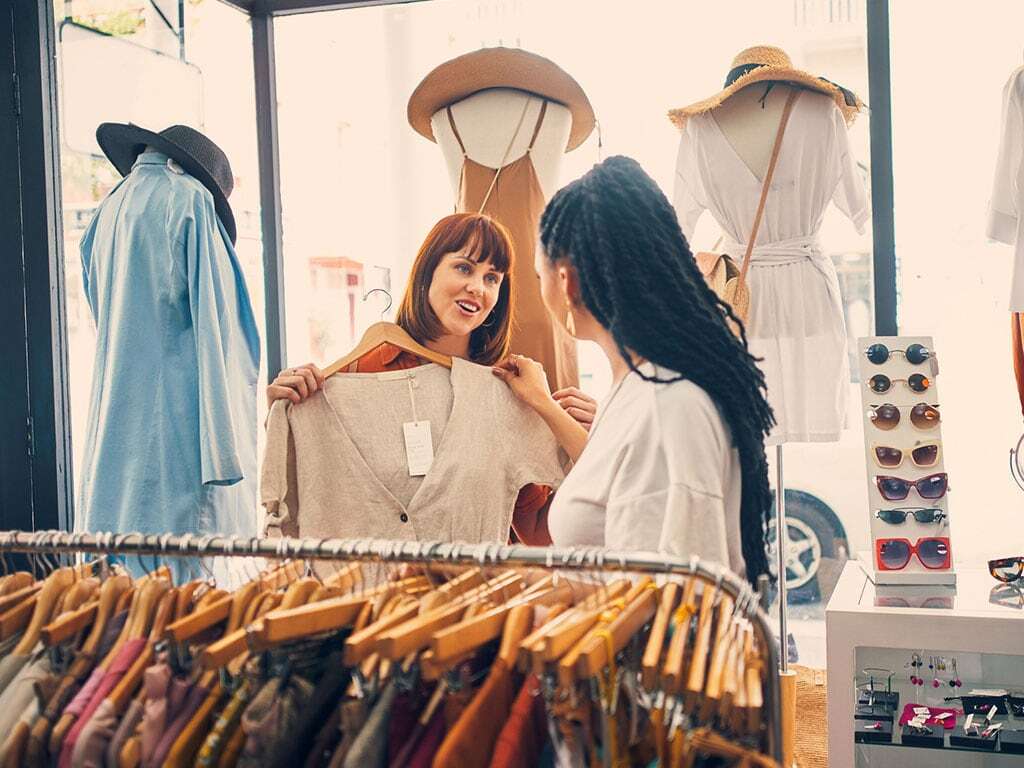 Women in shopping situation of clothing store; iStock-1195041974